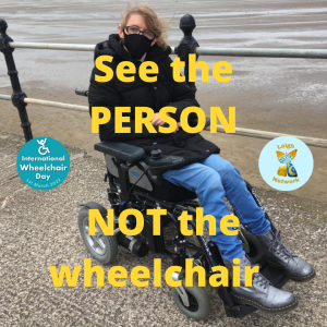 image of woman (Faye Wylie) pictured on New Brighton beach in her electric wheelchair. Yellow writing over the photo reads: SEE THE PERSON NOT THE WHEELCHAIR